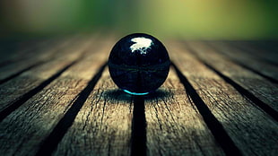 black marble toy on gray wooden panel HD wallpaper