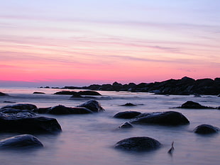 silhouette of stone in body of water, ocean beach
