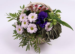 pink Daisies, purple Roses and pink Magnolias arrangement