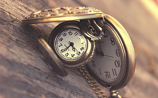 closeup photography of two opened pocket watches