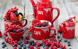 red ceramic jar set with assorted berries