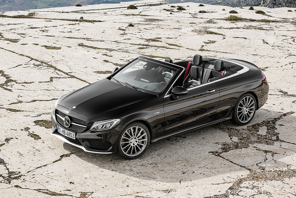 black Mercedes Benz convertible coupe on gray concrete surface HD wallpaper