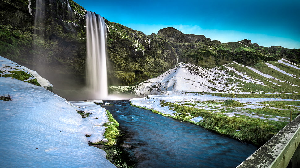 waterfalls surrounded with mountains covered with white snow HD wallpaper