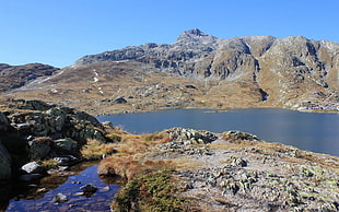 panoramic photography of mountains surrounded with body of water