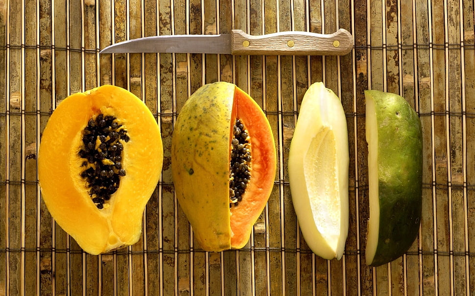 two sliced green and yellow papayas with knife HD wallpaper