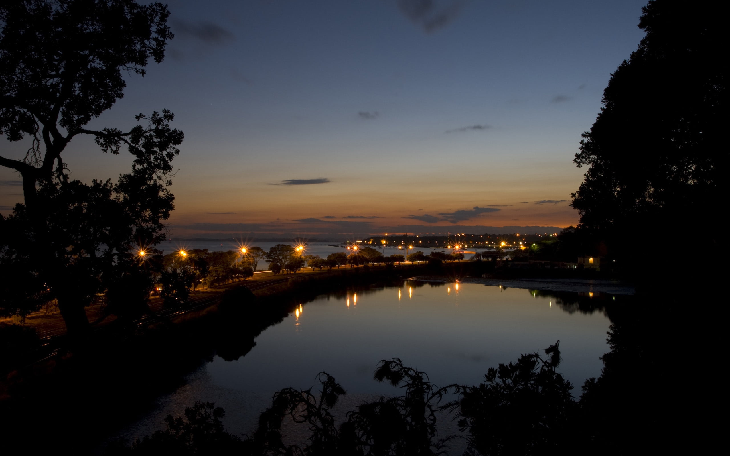 landscape photography of lampost near body of water