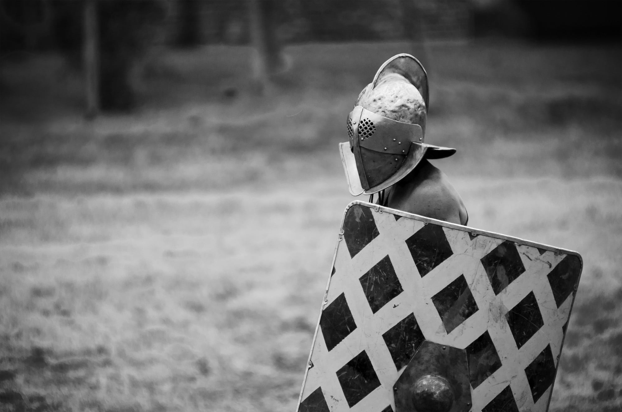 grayscale photo of man wearing knight armor helmet and shield, monochrome, warrior, gladiators