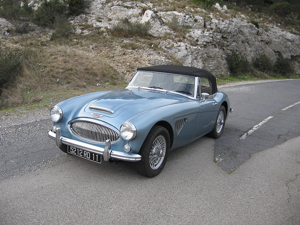 classic gray convertible coupe on black top road HD wallpaper