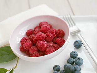 red berries on white bowl