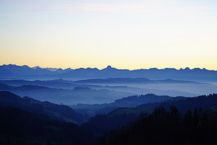 silhouette of mountain covered with fogs
