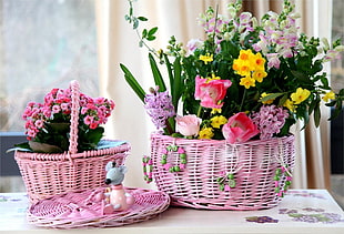 two baskets of artificial flowers