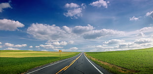 empty road between green grass under white and blue cloudy sky HD wallpaper