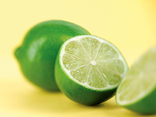two green sliced lemons