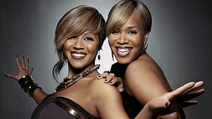 two females wearing tube dress on gray background