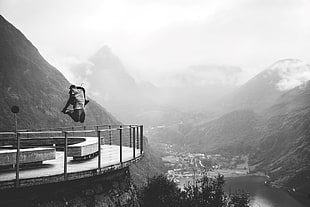 white and black concrete building, monochrome, men, mountains, jumping