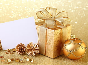 gold bauble beside gift box HD wallpaper