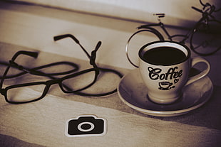 white and black ceramic coffee cup