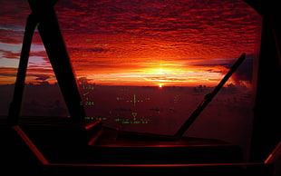 black flat screen TV with remote, sunset, aircraft, cockpit, HUD