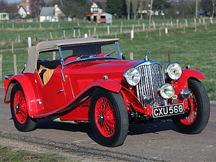 classic red and beige car on road