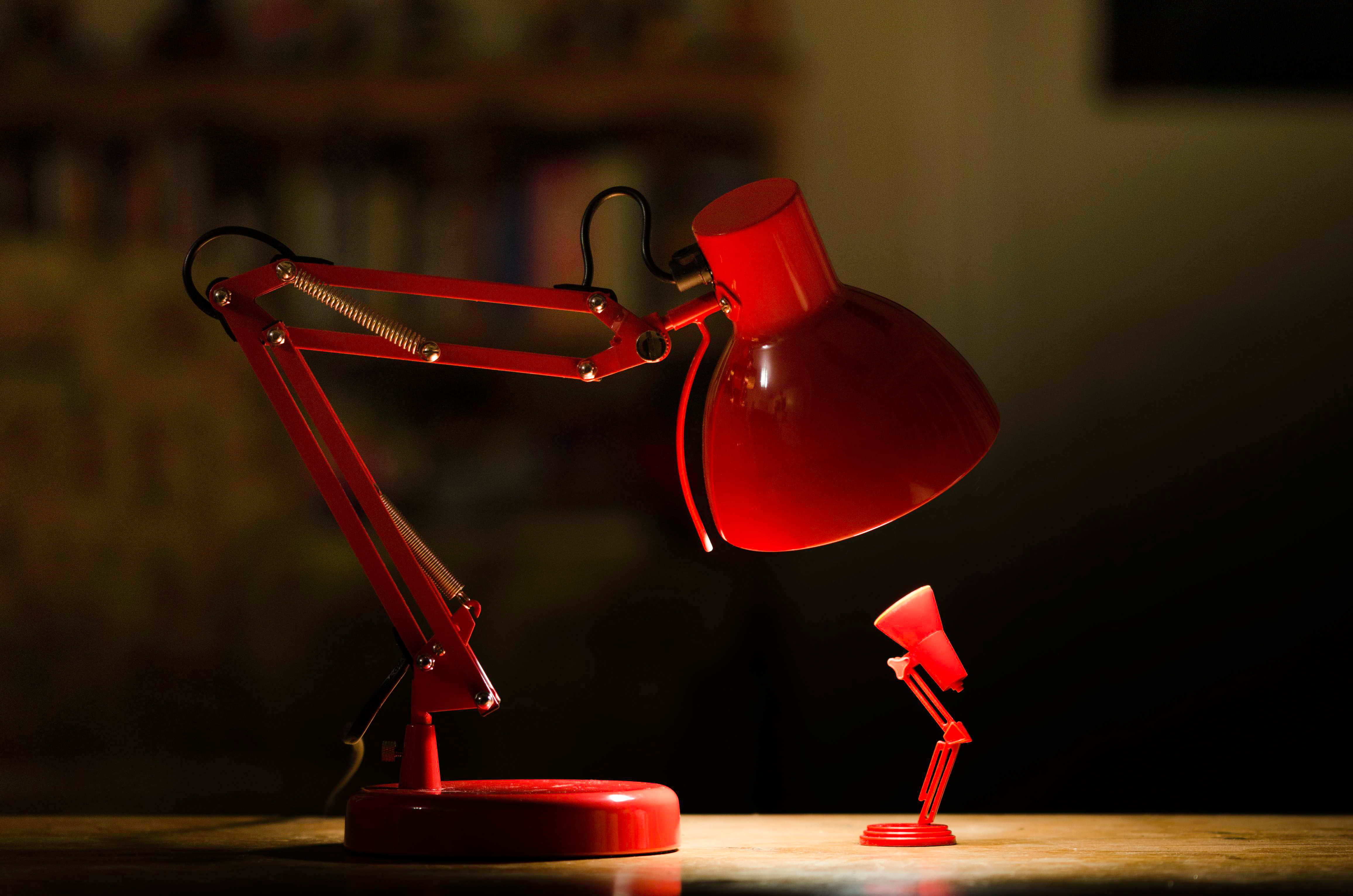 Red Desk Lamp Lighted On Top Of Brown Wooden Surface Hd Wallpaper