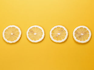 four slices of citrus fruit, yellow background, fruit, lemons, minimalism