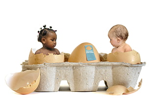 two babies inside cracked eggs