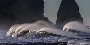 ocean waves near rock formation during daytime