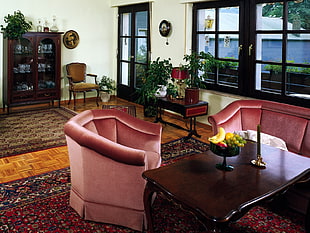 pink armchair near rectangular brown wooden coffee table