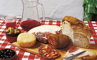 bread and raw meat near clear glass pither