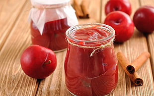 photography of clear glass jar filled of jam
