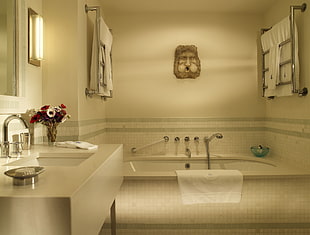 white towel hanged on the bathtub
