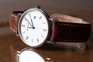 round silver analog Rider watch with brown leather strap HD wallpaper