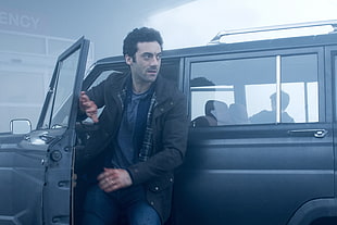 man wearing black jacket from SUV