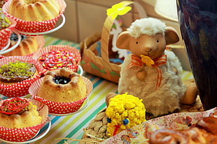 sheep plush toy beside cupcakes HD wallpaper