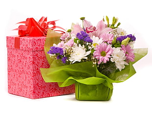 bouquet of pink Daisies with white Chrysanthemums and purple Statice flowers beside red gift box