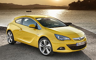 yellow Opel 3-door hatchback HD wallpaper