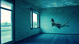 woman floating in front of a window photo