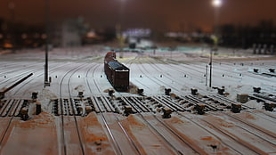 shallow focus photo of brown miniature train on rail tracks