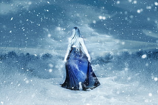 photo of women's blue gown in snow