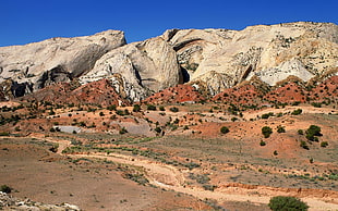 gray and white rock formation located on dessert during daytime HD wallpaper