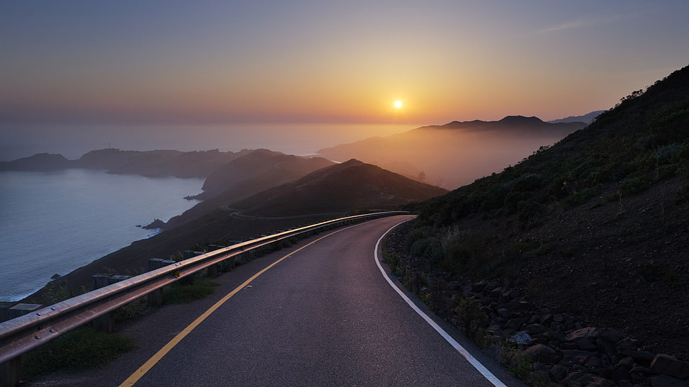 black and gray laptop computer, road, sunset, sea, mist HD wallpaper