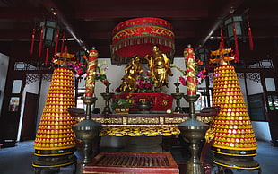 two yellow column with Hindu Deity statue on top