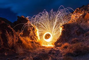 time lapse photo of sparkling spinning wagon wheel during night time