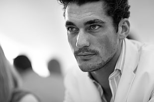 grayscale photography of man wearing white shirt