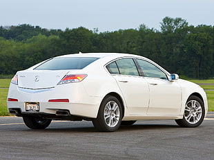 white Acura TL parked on gray concrete road during daytime