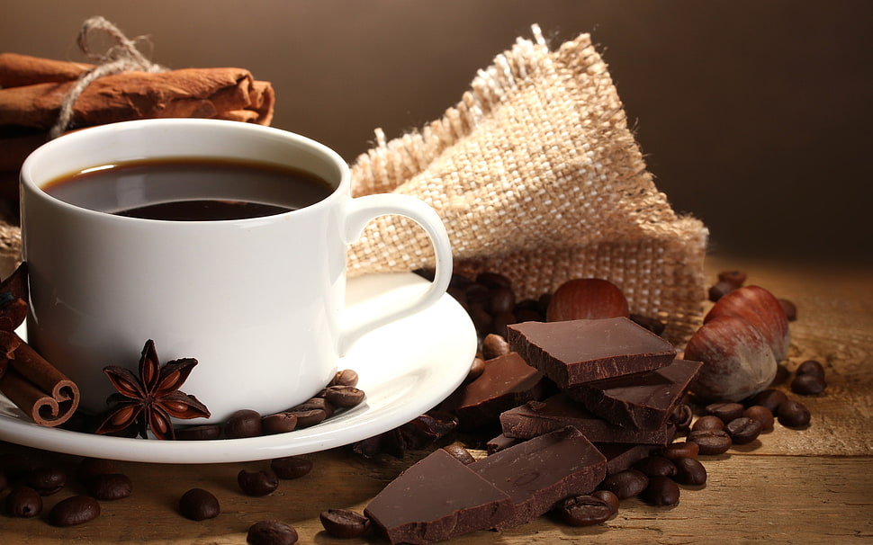 white teacup on top of pile of chocolates HD wallpaper