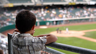 shallow focus photography of children on stadium