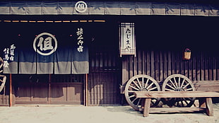 brown wooden house with black and white flag with kanji text print