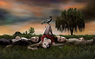 three persons laying on green grass poster HD wallpaper