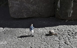 man standing beside brown snail figurine, nature, landscape, snail, animals